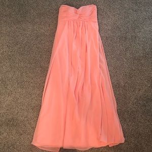 A coral long strapless dress